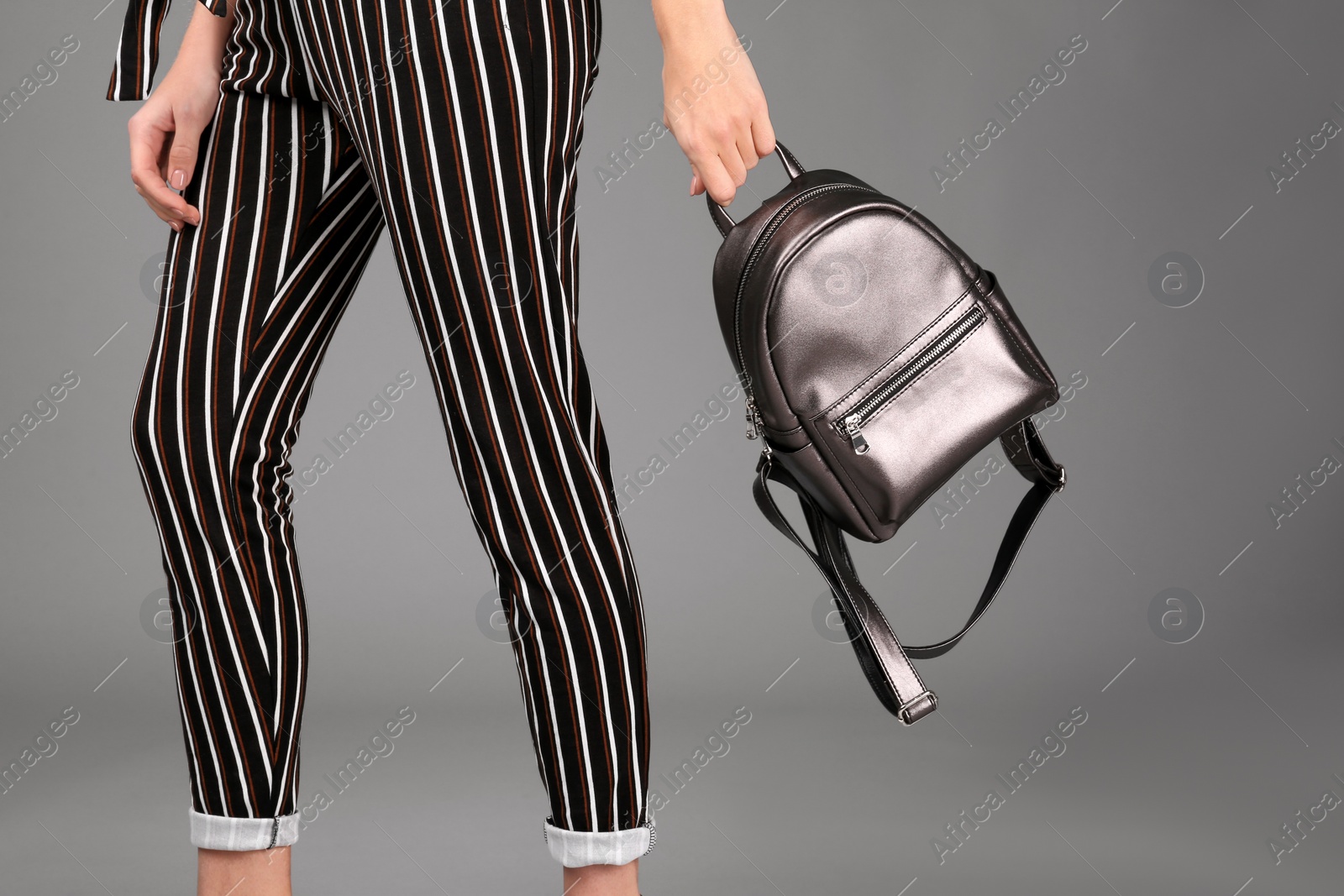 Photo of Woman with stylish backpack on grey background