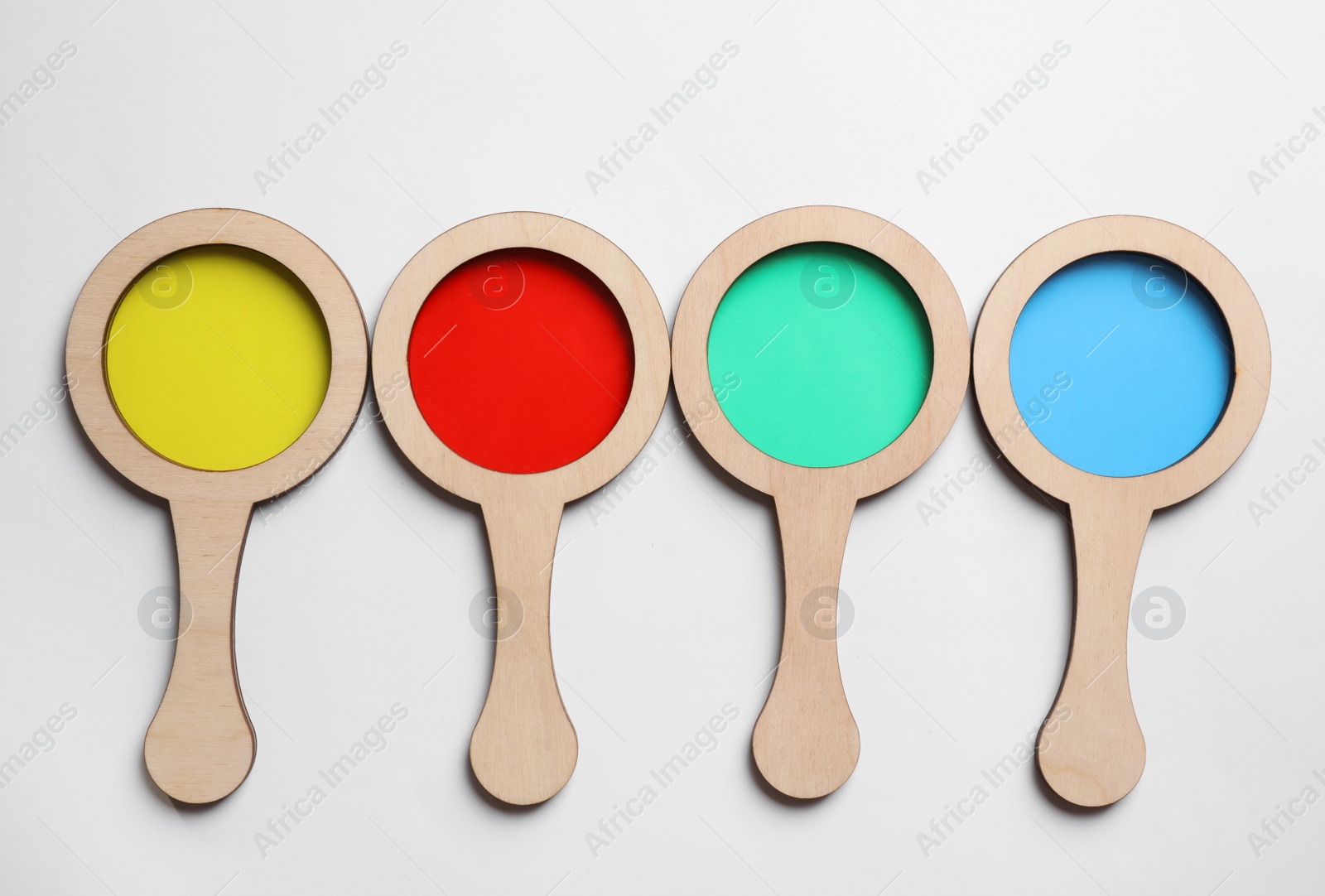 Photo of Set of colorful magnifiers on white background, top view. Montessori toy