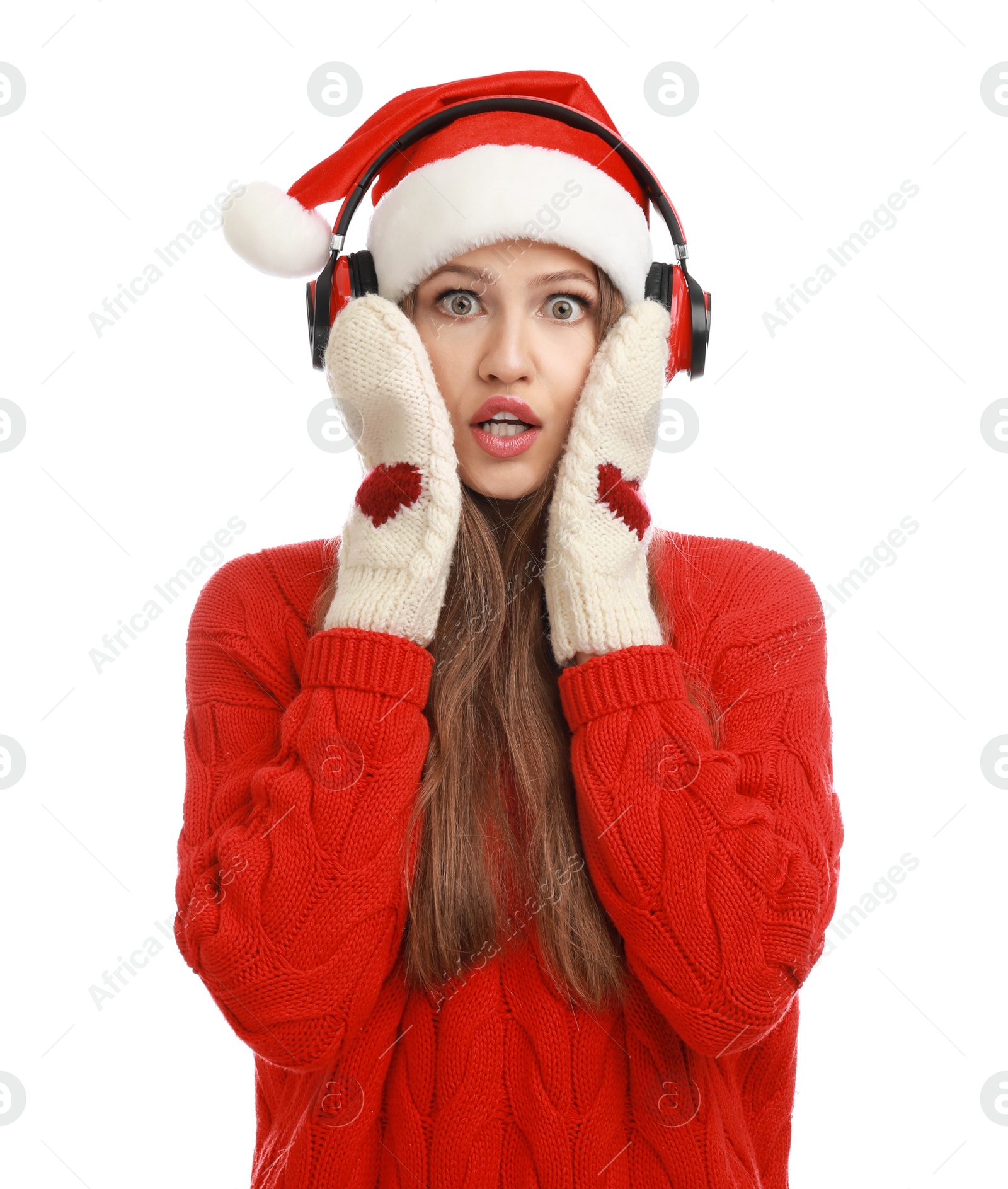 Photo of Young woman in Santa hat listening to Christmas music on white background