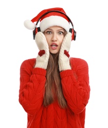 Photo of Young woman in Santa hat listening to Christmas music on white background