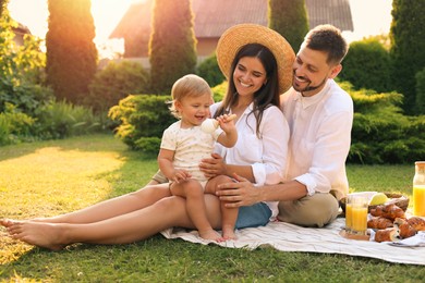 Photo of Happy family having picnic in garden on sunny day