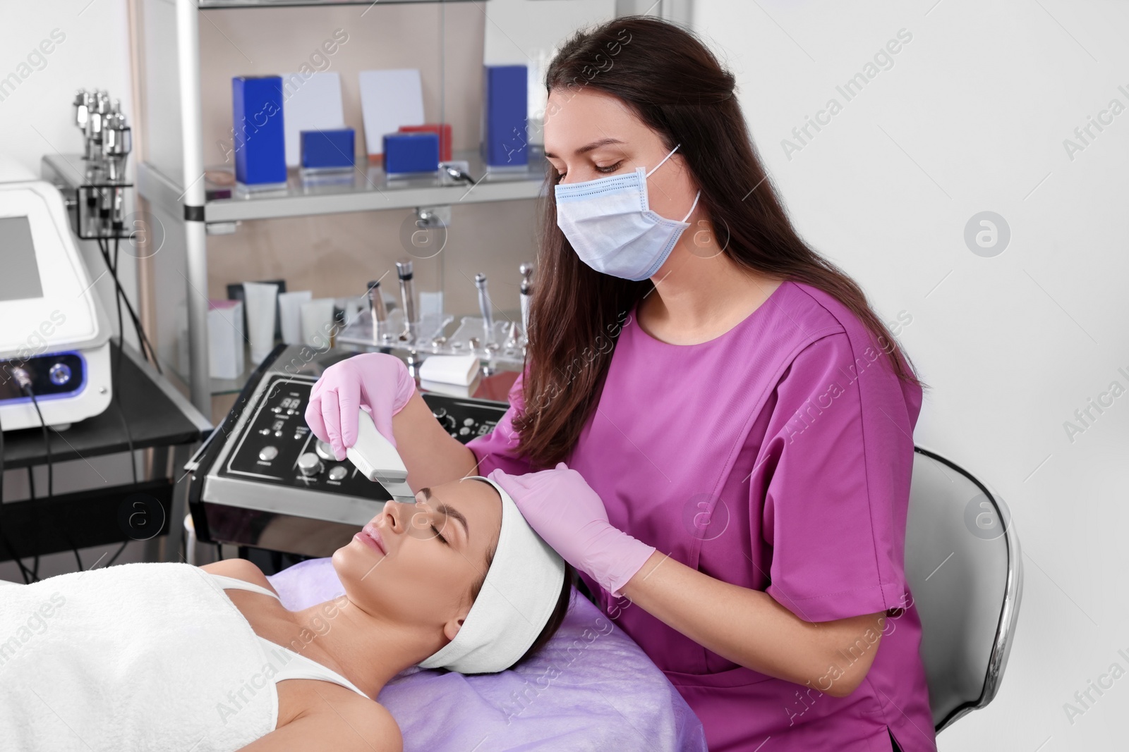 Photo of Young woman undergoing cosmetic procedure in beauty salon. Microcurrent therapy