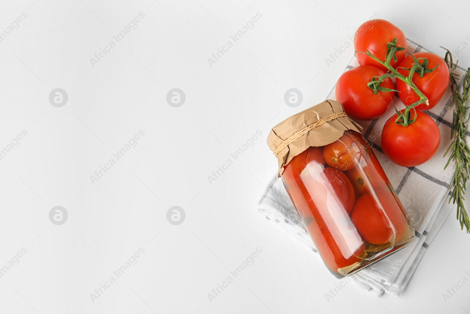 Photo of Flat lay composition with pickled tomatoes in glass jar on white table