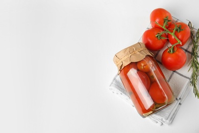 Photo of Flat lay composition with pickled tomatoes in glass jar on white table