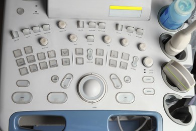 Photo of Ultrasound control panel with ultrasonic transducers and transmission gel, above view. Medical equipment