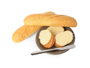 Photo of Whole and cut baguettes with fresh butter on white background, top view