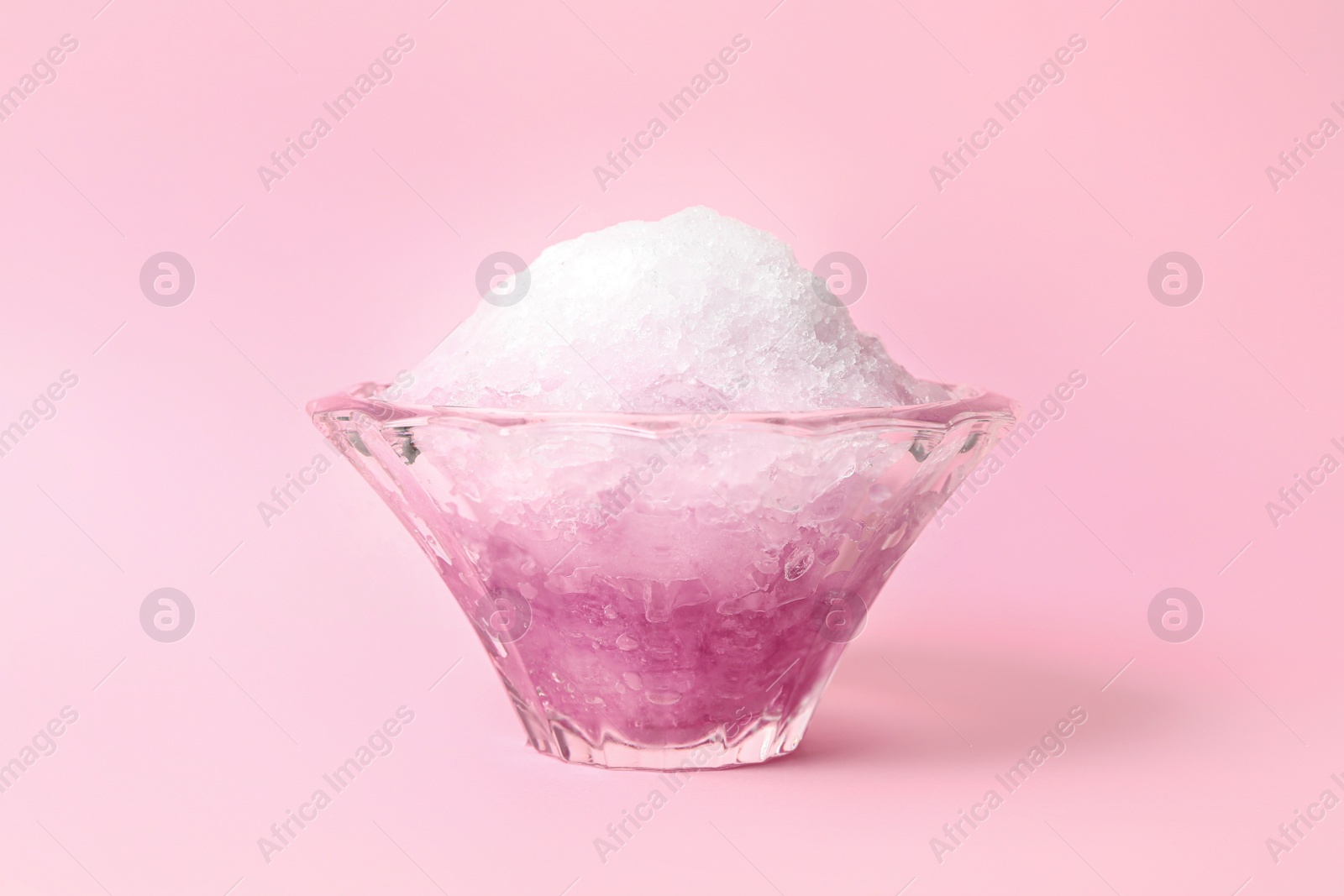 Photo of Shaving ice in glass dessert bowl on pink background, closeup