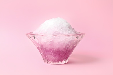 Photo of Shaving ice in glass dessert bowl on pink background, closeup