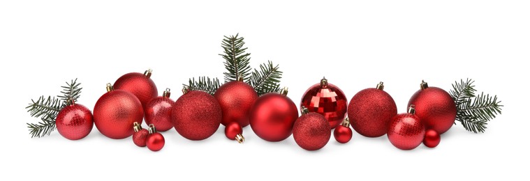 Red Christmas balls and fir twigs isolated on white