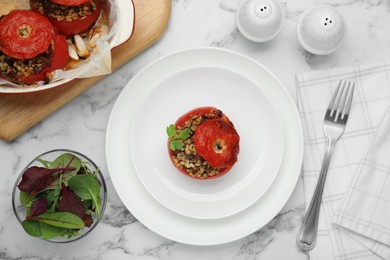 Photo of Delicious stuffed tomatoes with minced beef, bulgur and mushrooms on white marble table, flat lay