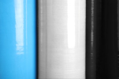 Rolls of different stretch wrap as background, closeup