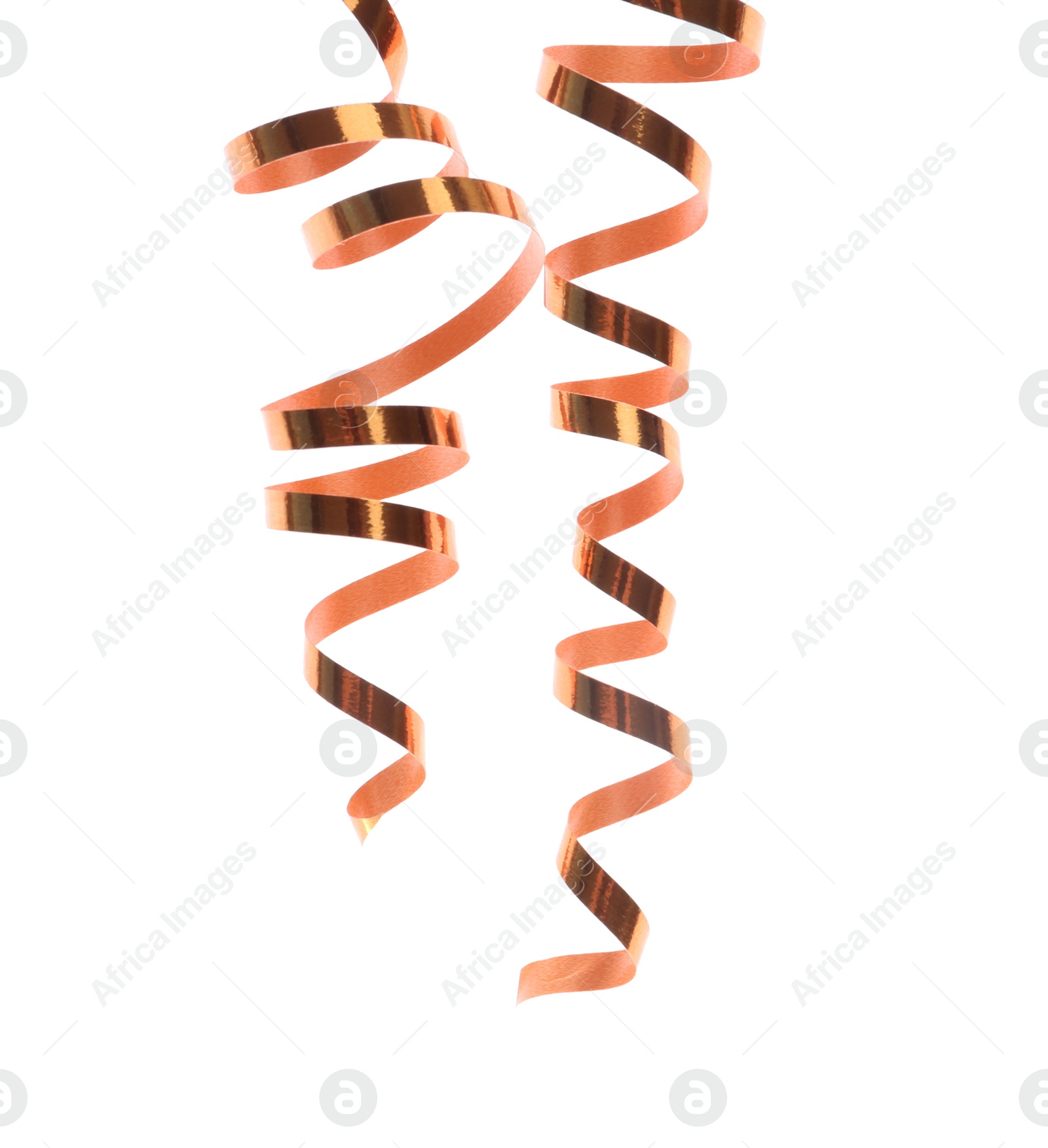 Photo of Shiny serpentine streamers on white background. Festive decor