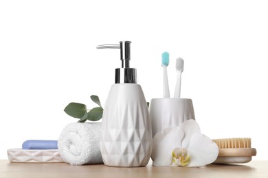Photo of Bath accessories. Different personal care products and flower on wooden table against white background