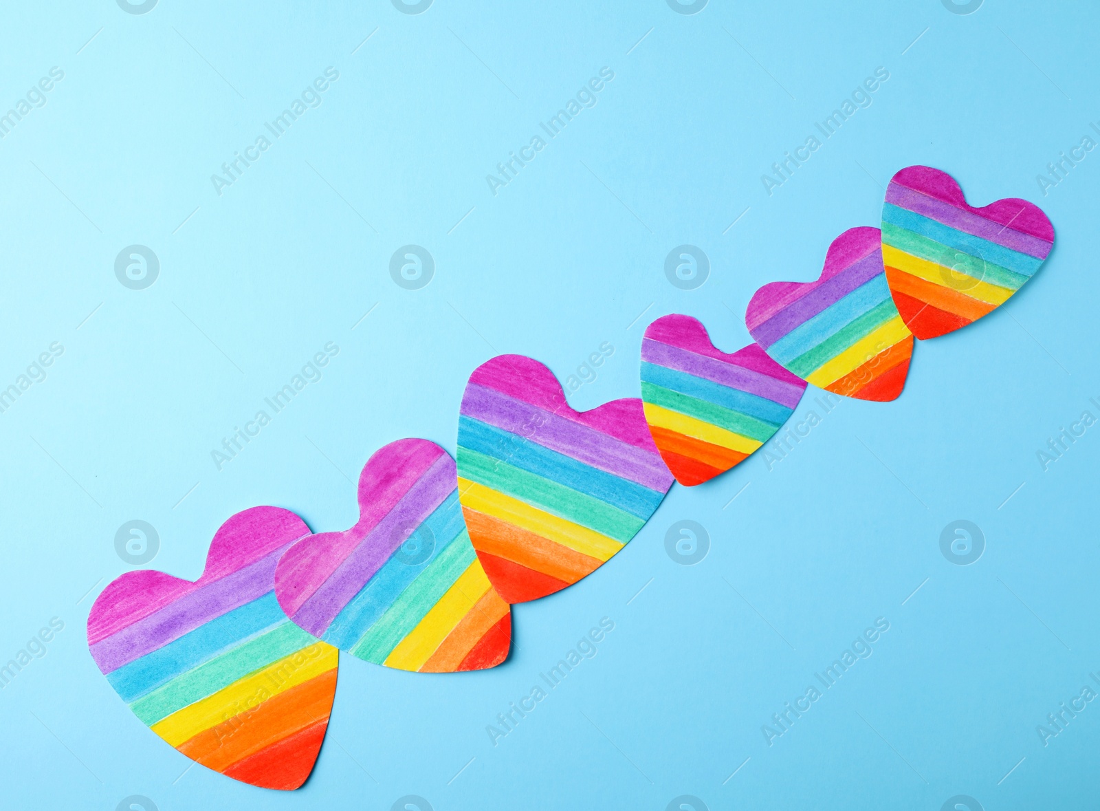 Photo of Rainbow hearts on color background, top view. Gay symbol