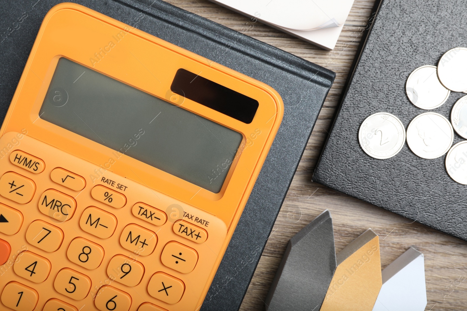 Photo of Calculator, stationery and money on wooden table, flat lay. Tax accounting