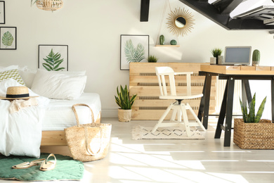 Photo of Elegant interior of bedroom with workplace under stairs