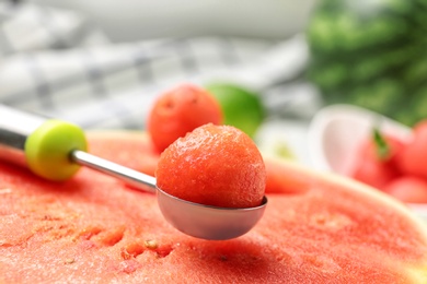 Photo of Scoop with delicious juicy watermelon on table, closeup
