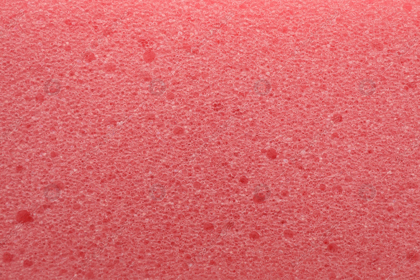 Photo of Pink cleaning sponge as background, top view