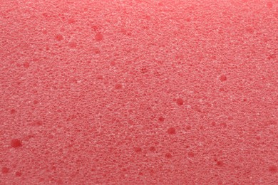 Pink cleaning sponge as background, top view