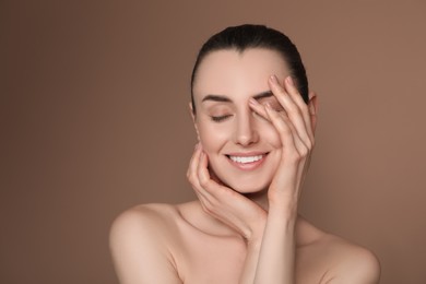 Portrait of beautiful young woman on brown background. Space for text