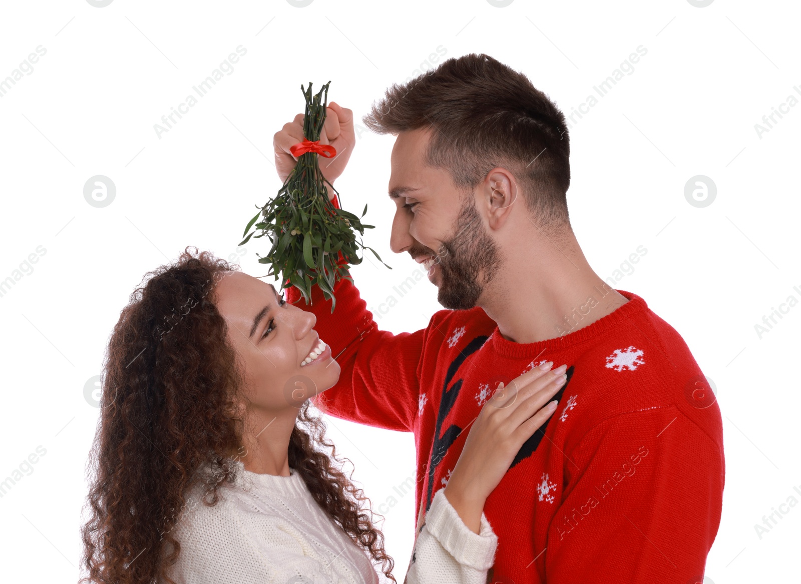 Photo of Lovely couple under mistletoe bunch on white background