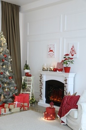 Living room with fireplace and Christmas decorations. Festive interior design