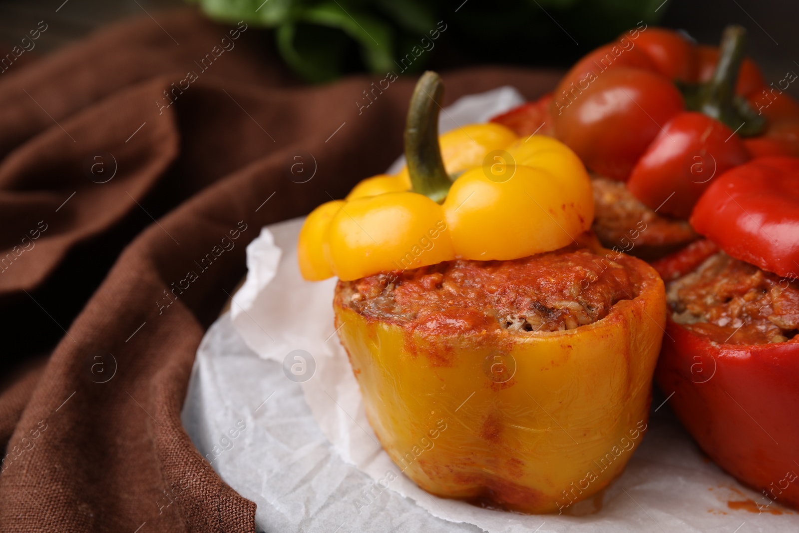 Photo of Delicious stuffed bell peppers served on table, closeup