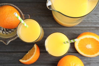 Photo of Flat lay composition with orange juice and fresh fruit on wooden background