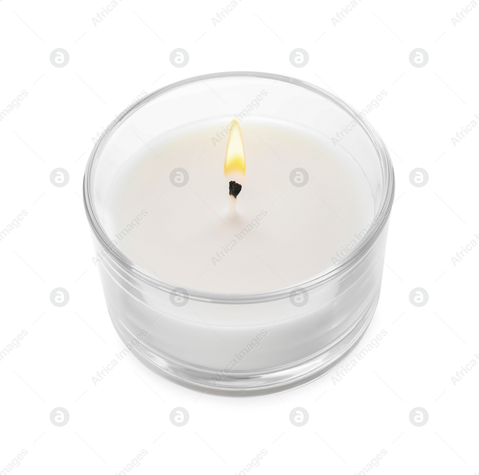 Photo of Burning small wax candle in glass holder isolated on white