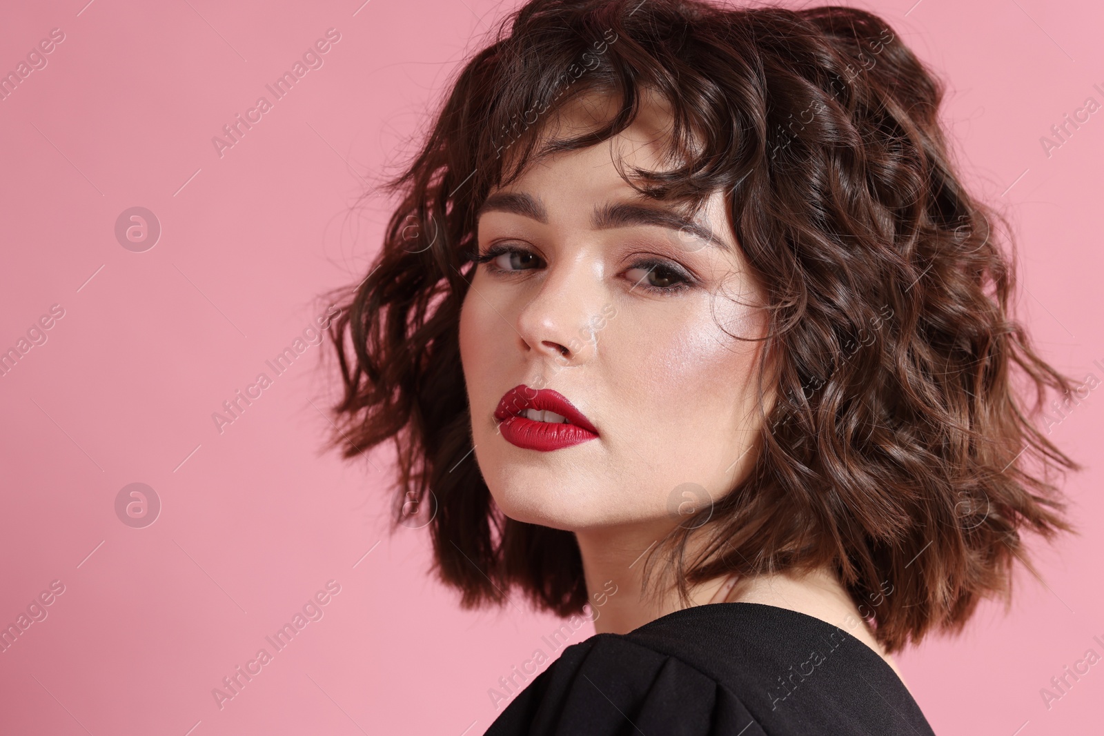 Photo of Portrait of beautiful young woman with wavy hairstyle on pink background. Space for text