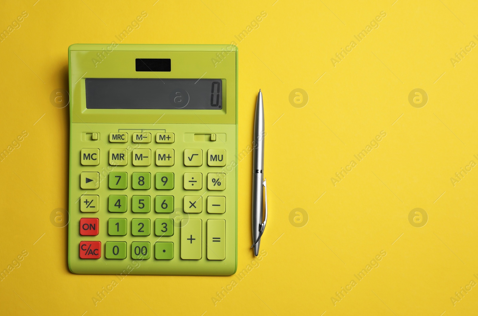 Photo of Calculator and pen on yellow background, flat lay with space for text