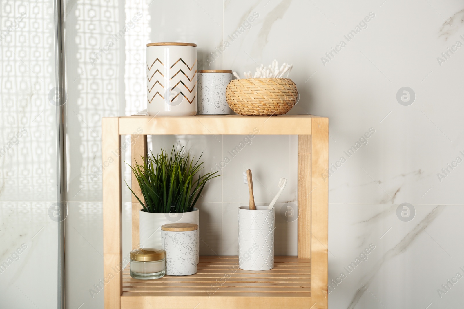 Photo of Shelving unit with toiletries in bathroom interior