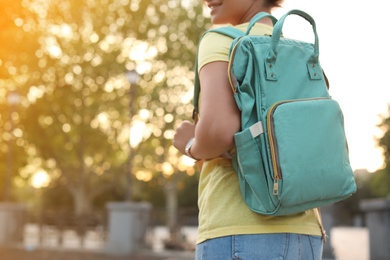 Young woman with stylish turquoise bag outdoors, closeup