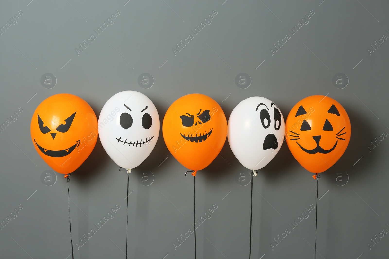 Photo of Color balloons for Halloween party on gray background