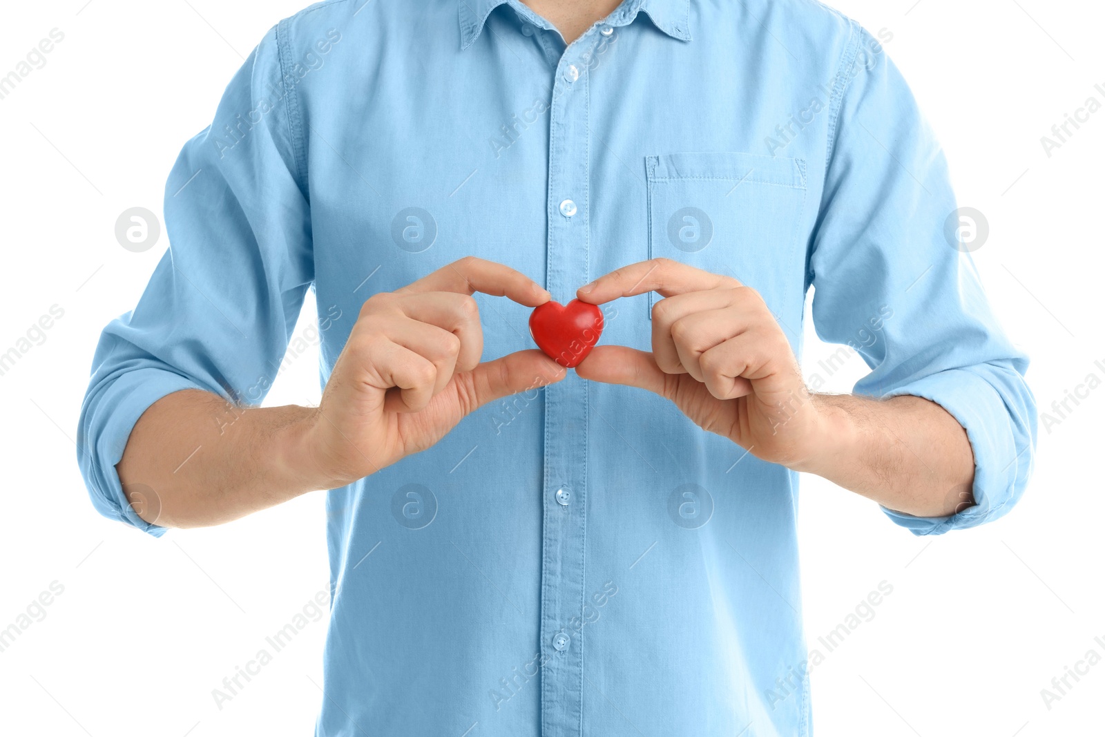 Photo of Man holding small red heart on white background. Heart attack concept