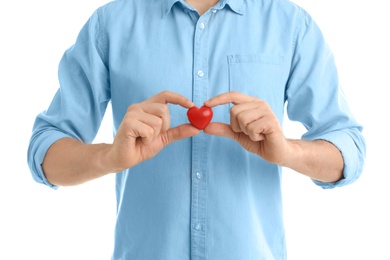 Photo of Man holding small red heart on white background. Heart attack concept