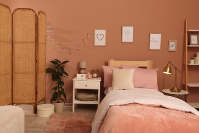 Teenage girl's bedroom interior with stylish furniture and beautiful decor elements