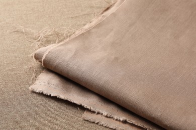 One folded light brown fabric on cloth, closeup