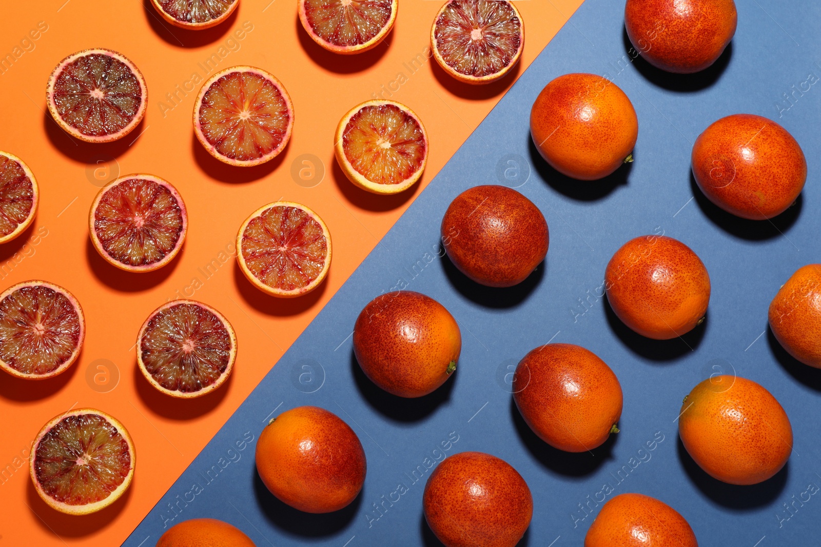 Photo of Many ripe sicilian oranges on color background, flat lay