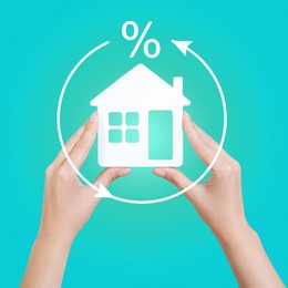 Image of Mortgage concept. Woman holding house model on turquoise background, closeup