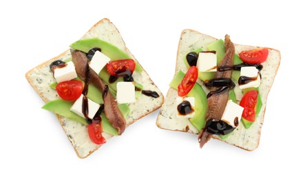 Delicious sandwiches with anchovy, cheese, tomato and sauce on white background, top view
