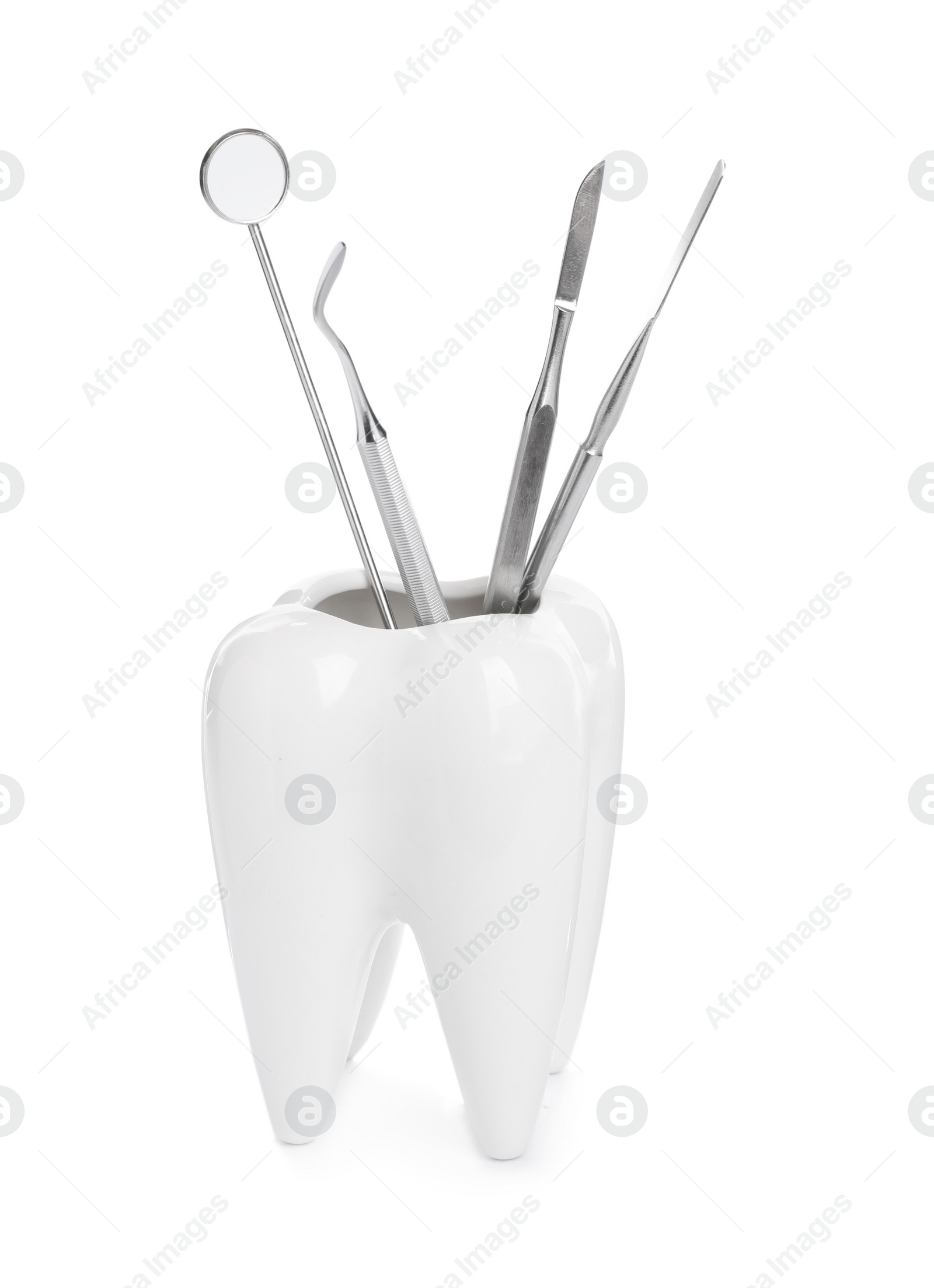 Photo of Tooth shaped holder with dental tools on white background