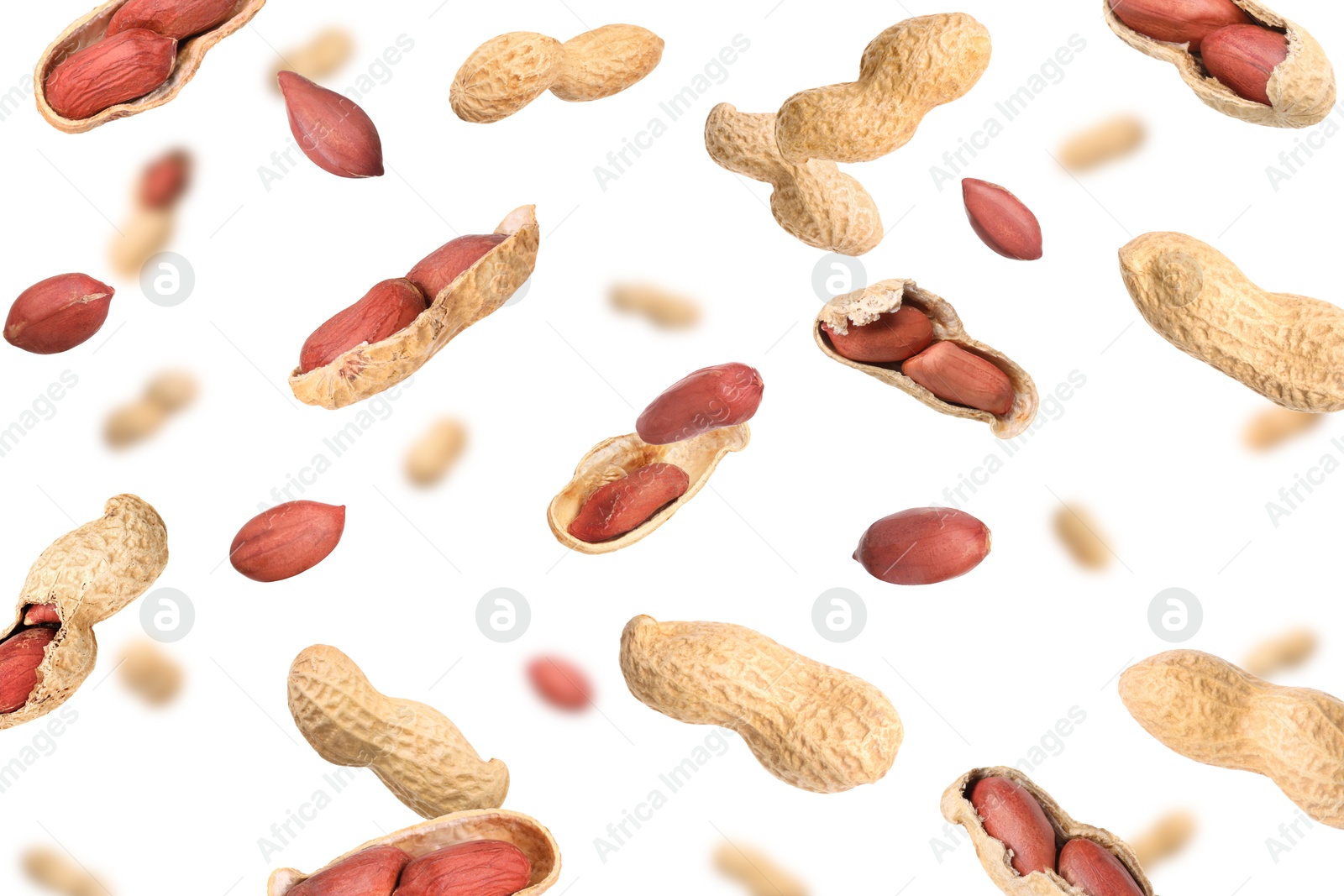 Image of Unpeeled peanuts in air on white background