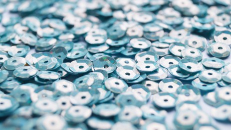 Photo of Many beautiful turquoise sequins as background, closeup