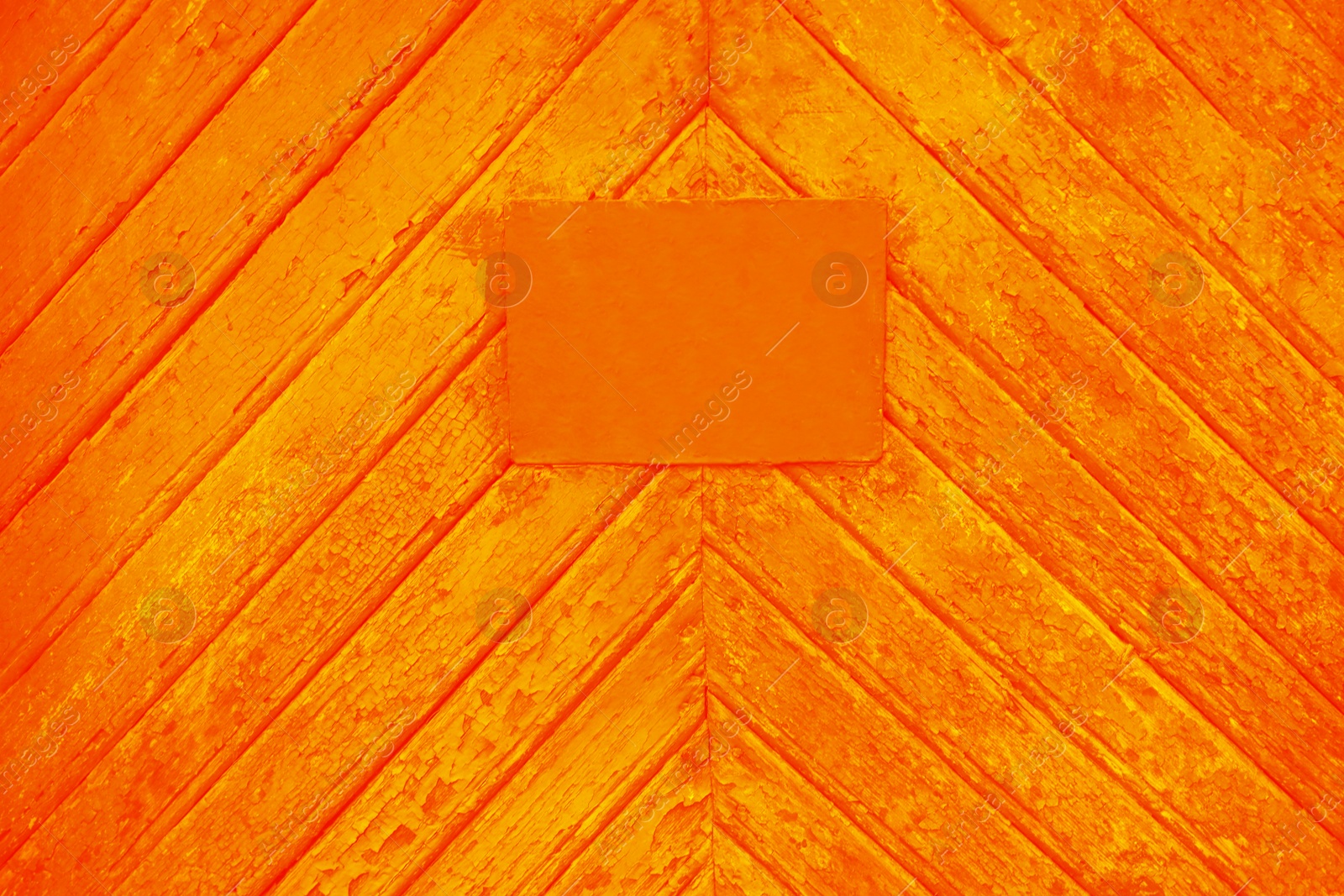 Image of Textured orange wooden surface with stained signboard as background