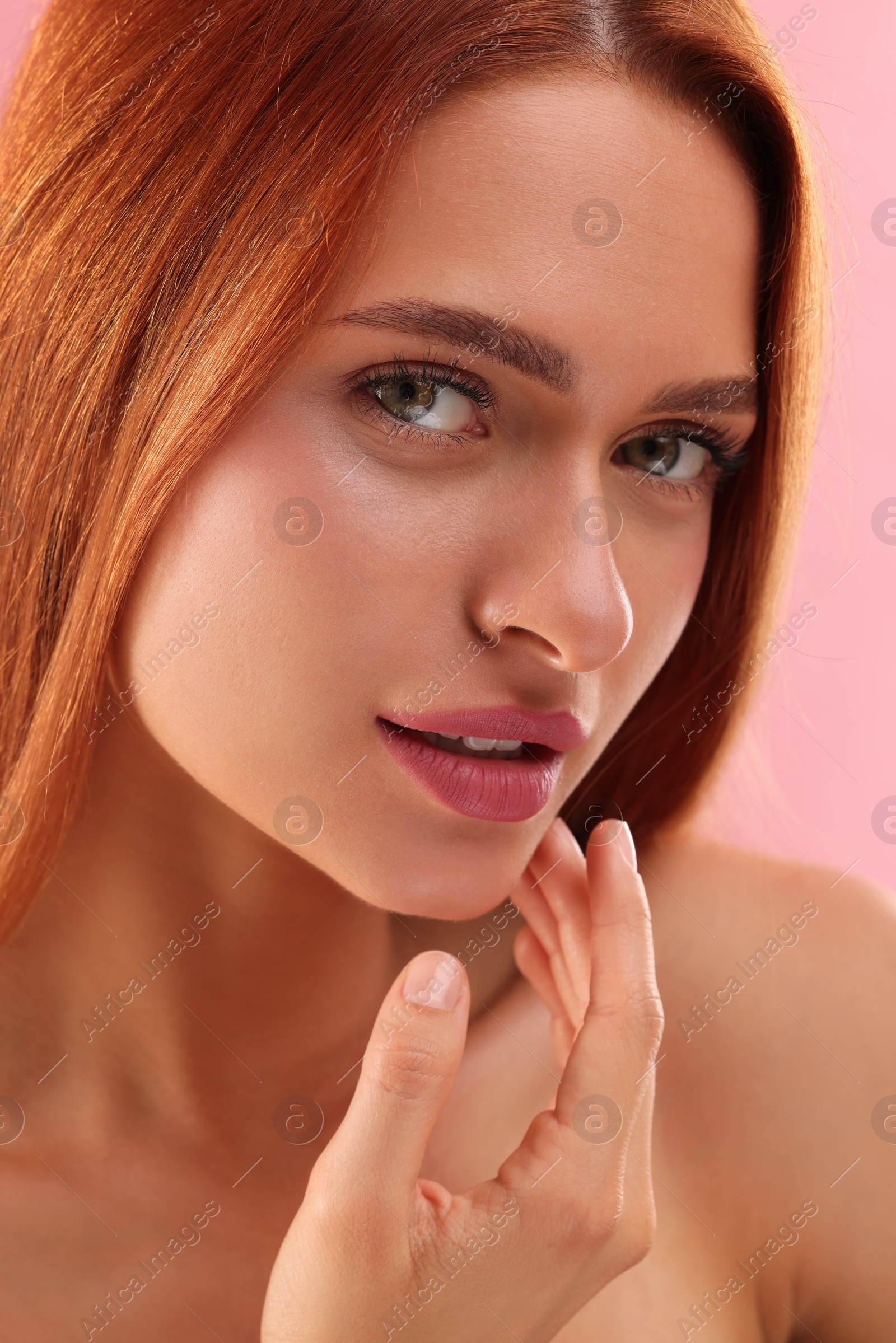 Photo of Portrait of beautiful young woman on pink background, closeup