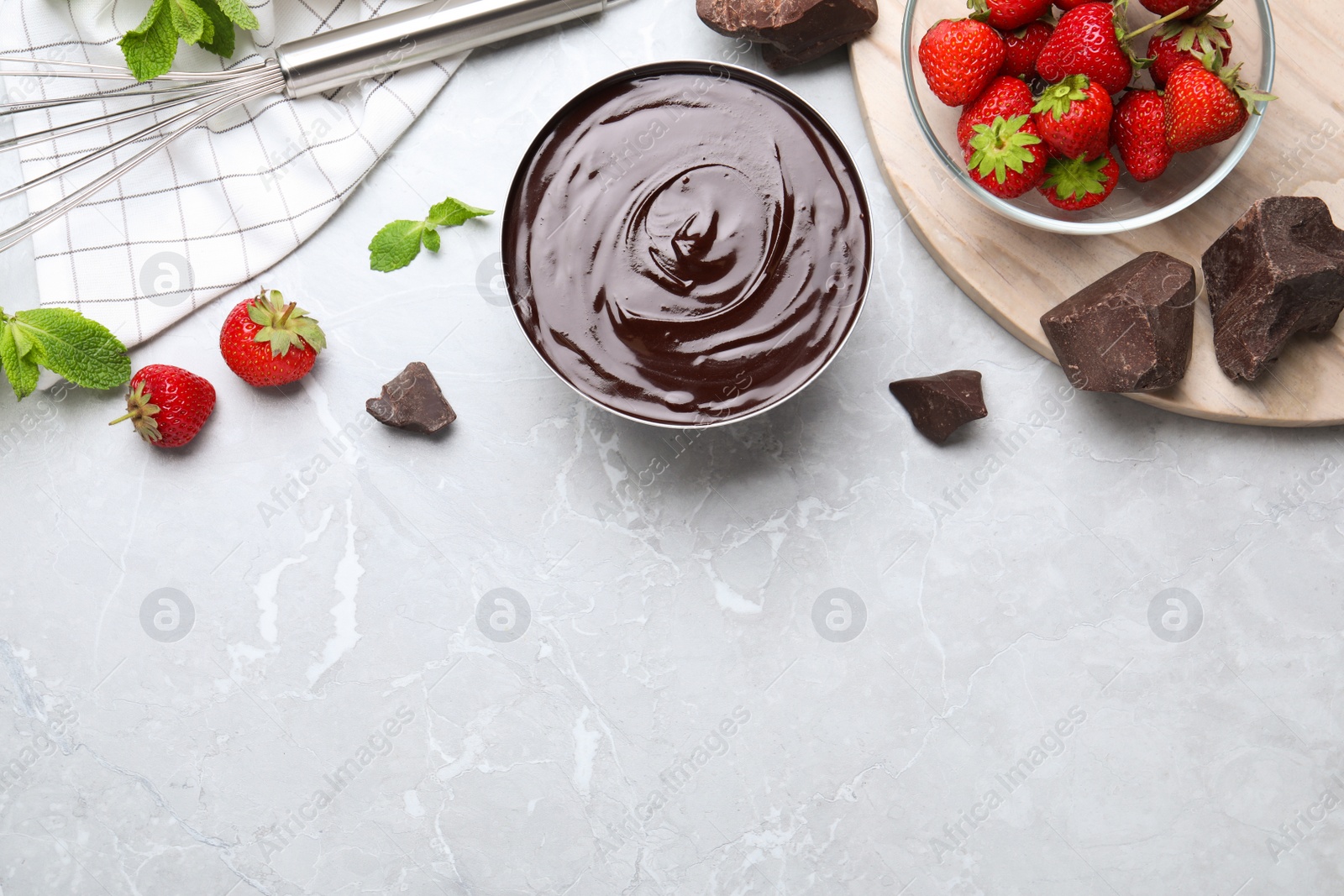 Photo of Delicious chocolate cream with strawberries and mint on light grey marble table, flat lay. Space for text