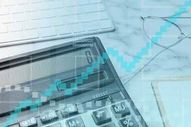 Image of Calculator, keyboard and glasses on white marble table, closeup