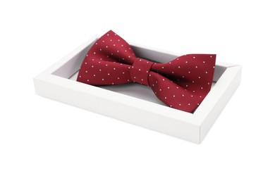 Stylish burgundy bow tie with polka dot pattern on white background