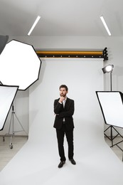 Photo of Handsome model posing in modern studio. Professional photo session